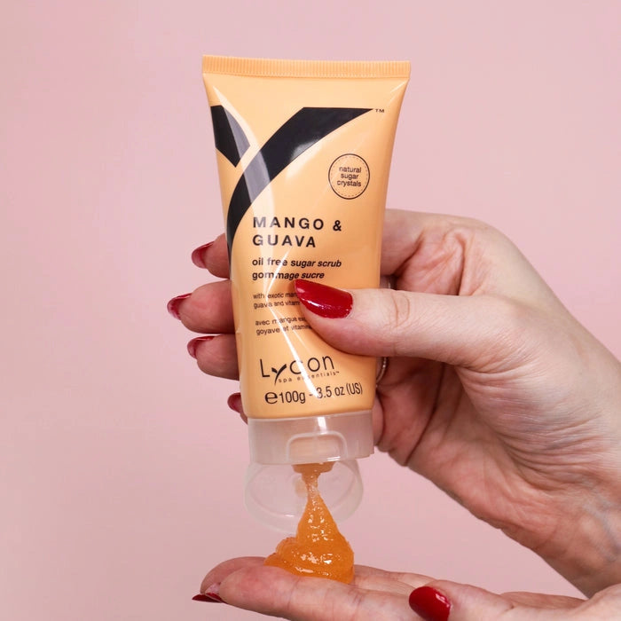 Lycon Mango & Guava Sugar Scrub 100g in hand, showcasing smooth orange scrub texture, perfect for summer skin care.