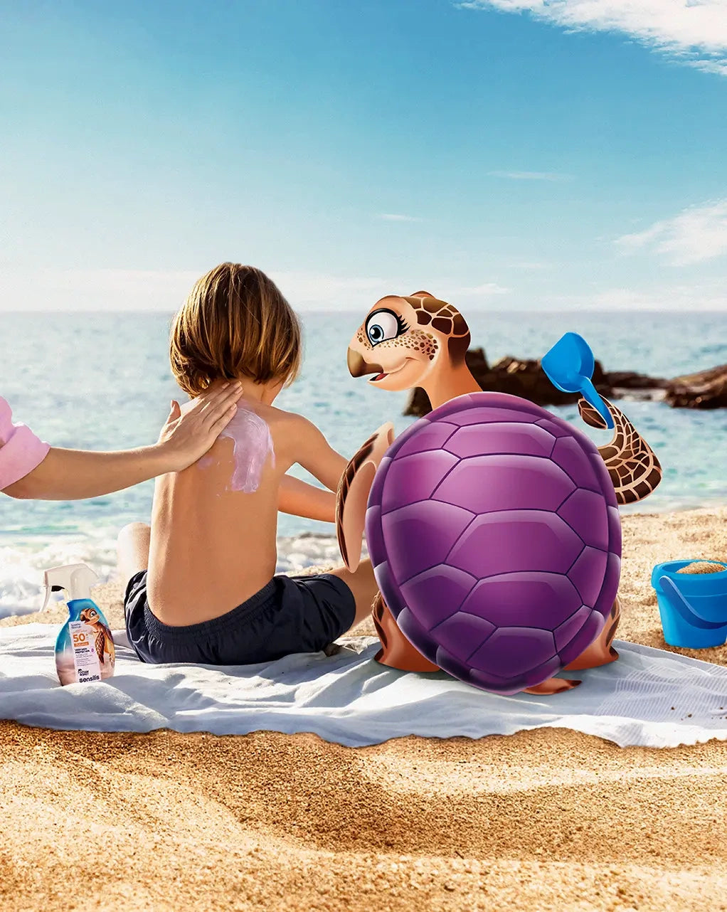 Sensilis Lotion Spray 50+ Kids 200ml in gebruik op een kind dat zonnebrand krijgt aangebracht op het strand