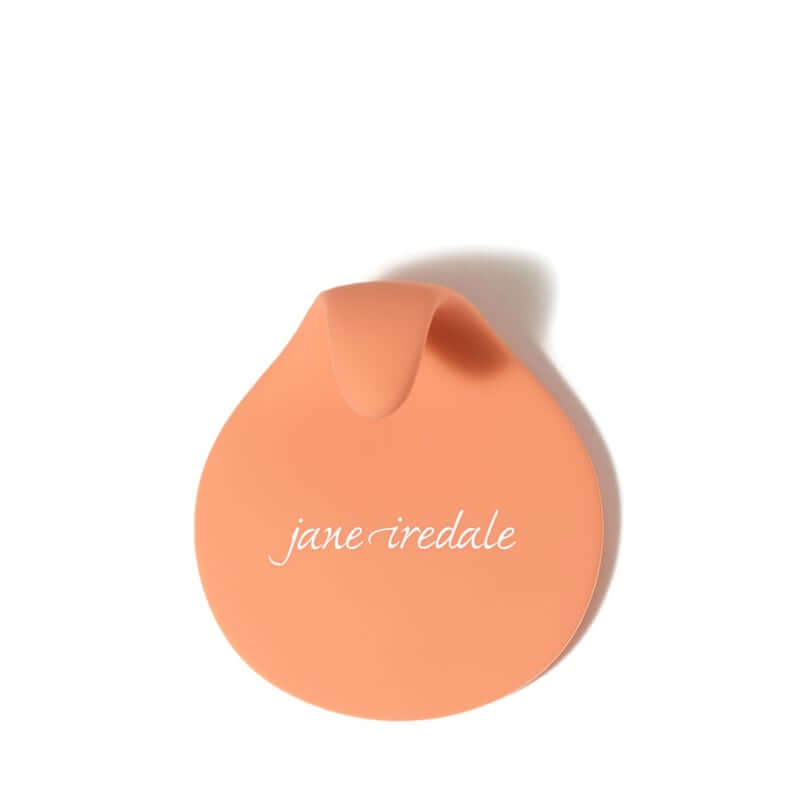 Jane Iredale - Brush Cleansing Pad in zacht oranje, ideaal voor het efficiënt reinigen van make-up penselen.